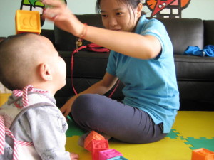 Olivia's Place Speech-Language Pathologist Angela Gong works with an infant during her recent trip to Inner Mongolia