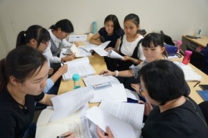 Training program participants working on a case analysis in a multidisciplinary team setting. 